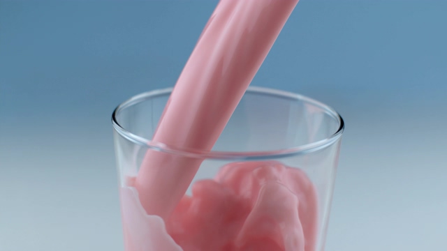 4K向杯子里倒入粉色的牛奶酸奶视频素材