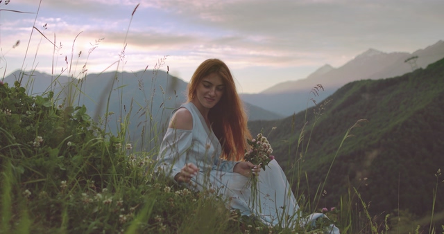 山顶视频素材坐在山顶上草丛中的美女
